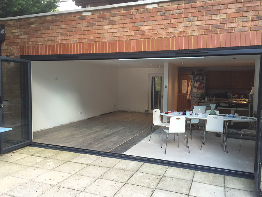 Anthracite grey aluminium bi-folding doors, 6 sections, (open).