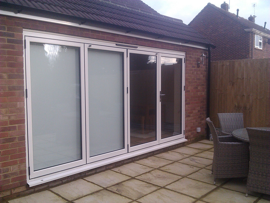 White aluminium bi-folding doors, 4 sections.